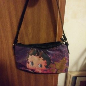 A small hand bag with betty boop on the front